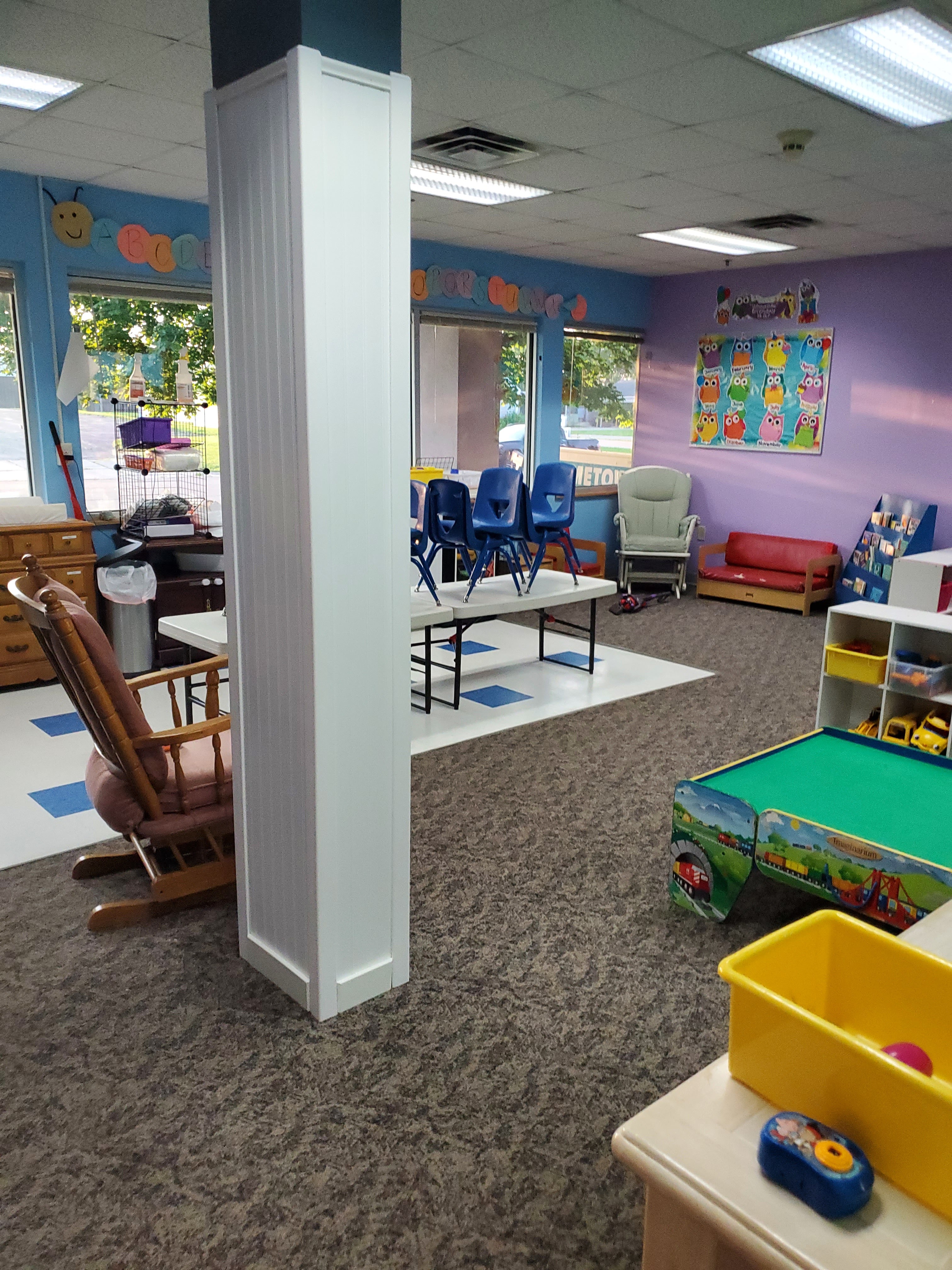Colorful classroom with play areas and learning stations
